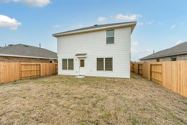 a view of a house with a backyard and a window
