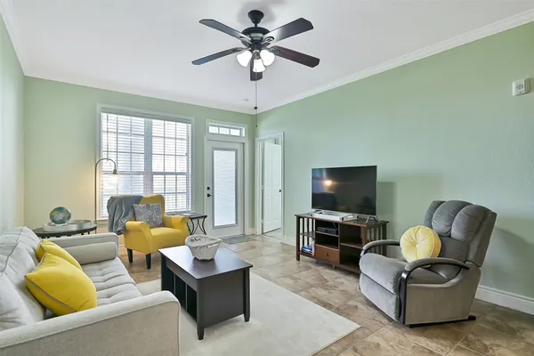 a living room with furniture and a flat screen tv