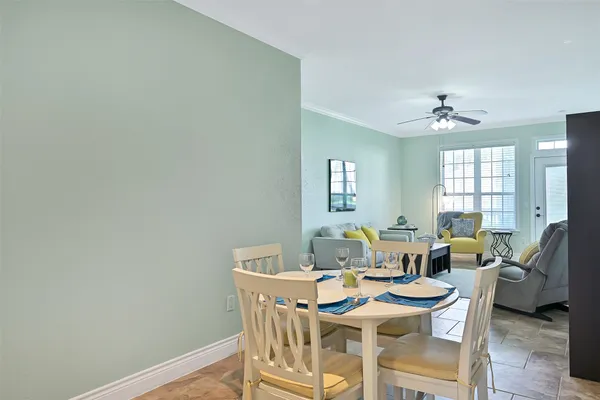 a view of a dining room with furniture and a chandelier