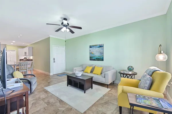 a living room with furniture and a chandelier