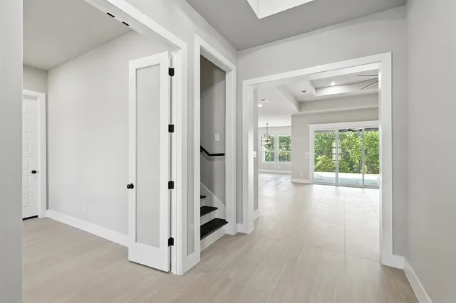 a view of a hallway with wooden floor and a cabinet