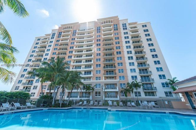 3232 Southwest 22nd Terrace, Unit 910 Miami, FL 33145 - Photo 1 of 31 a front view of a building with swimming pool