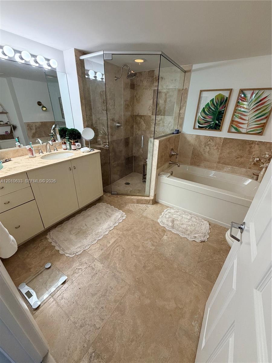 3232 Southwest 22nd Terrace, Unit 910 Miami, FL 33145 - Photo 12 of 31 a bathroom with a double vanity sink mirror and shower