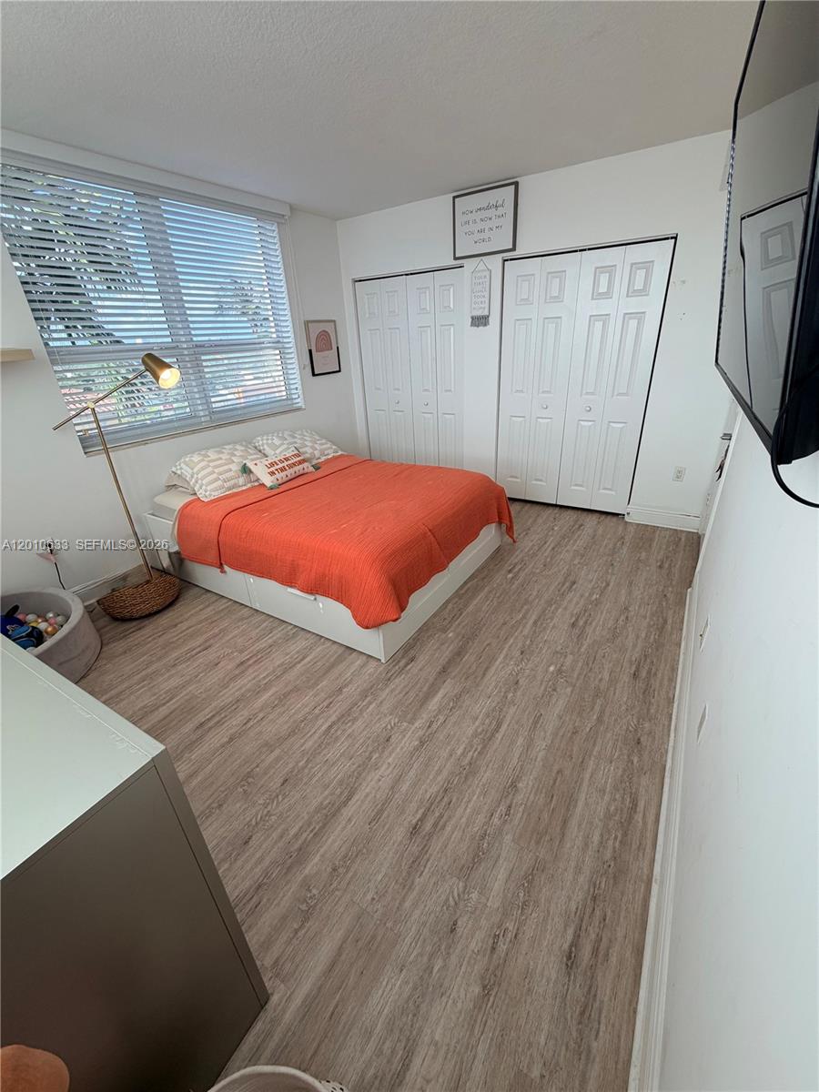 3232 Southwest 22nd Terrace, Unit 910 Miami, FL 33145 - Photo 15 of 31 a bedroom with a bed and a flat screen tv
