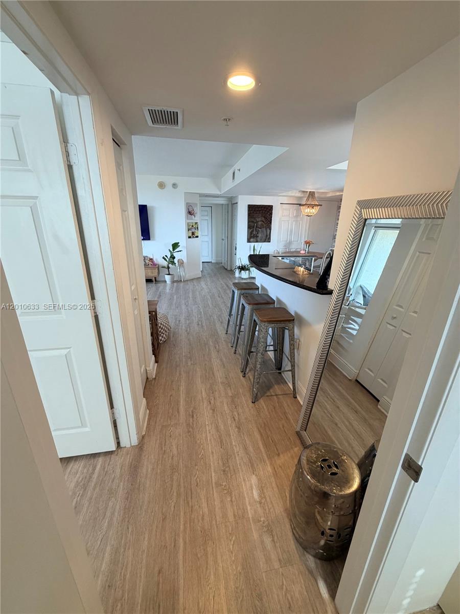 3232 Southwest 22nd Terrace, Unit 910 Miami, FL 33145 - Photo 19 of 31 a living room with furniture and a wooden floor