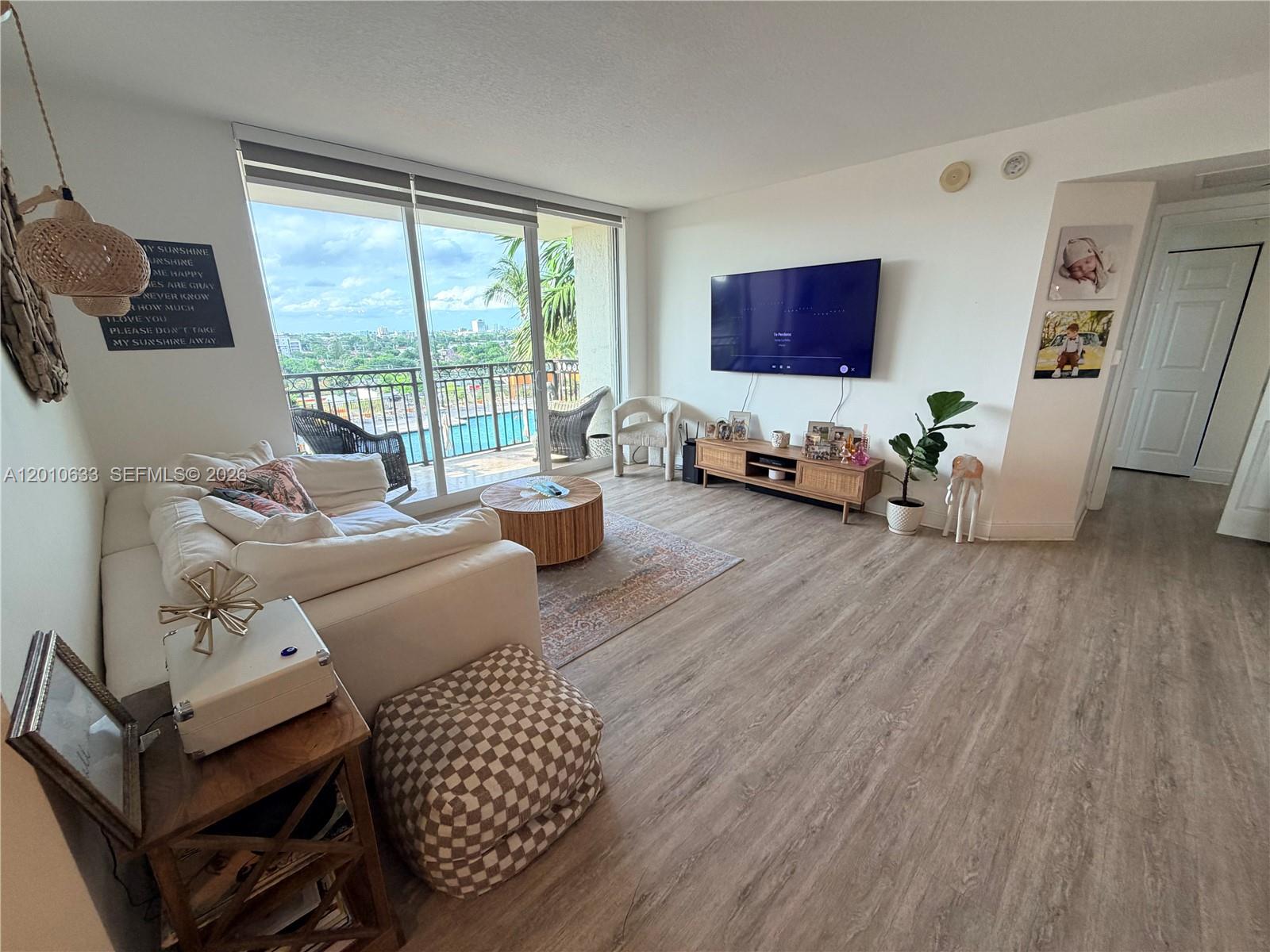 3232 Southwest 22nd Terrace, Unit 910 Miami, FL 33145 - Photo 3 of 31 a living room with furniture and wooden floor
