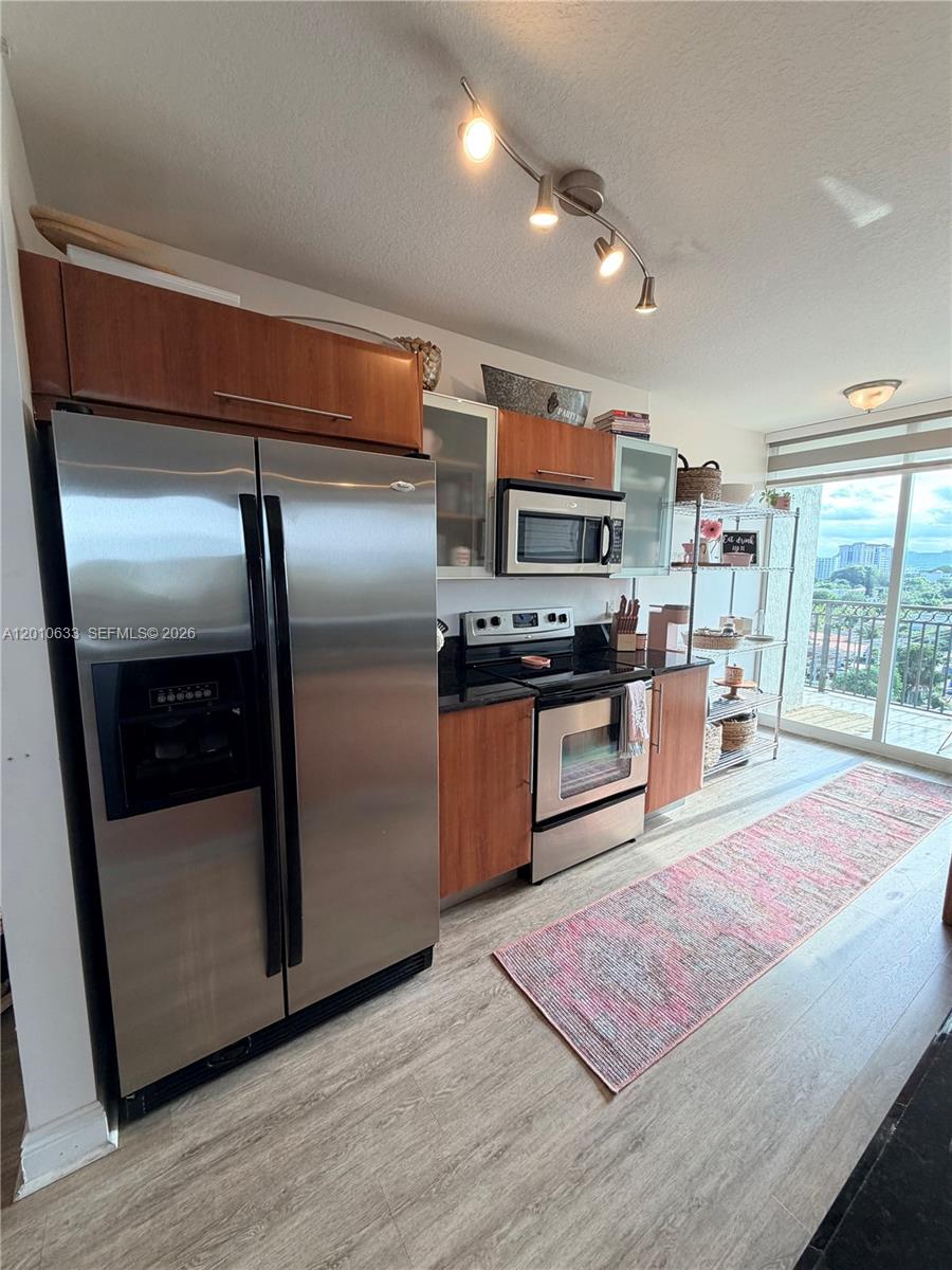 3232 Southwest 22nd Terrace, Unit 910 Miami, FL 33145 - Photo 8 of 31 a kitchen with stainless steel appliances granite countertop a refrigerator and a stove