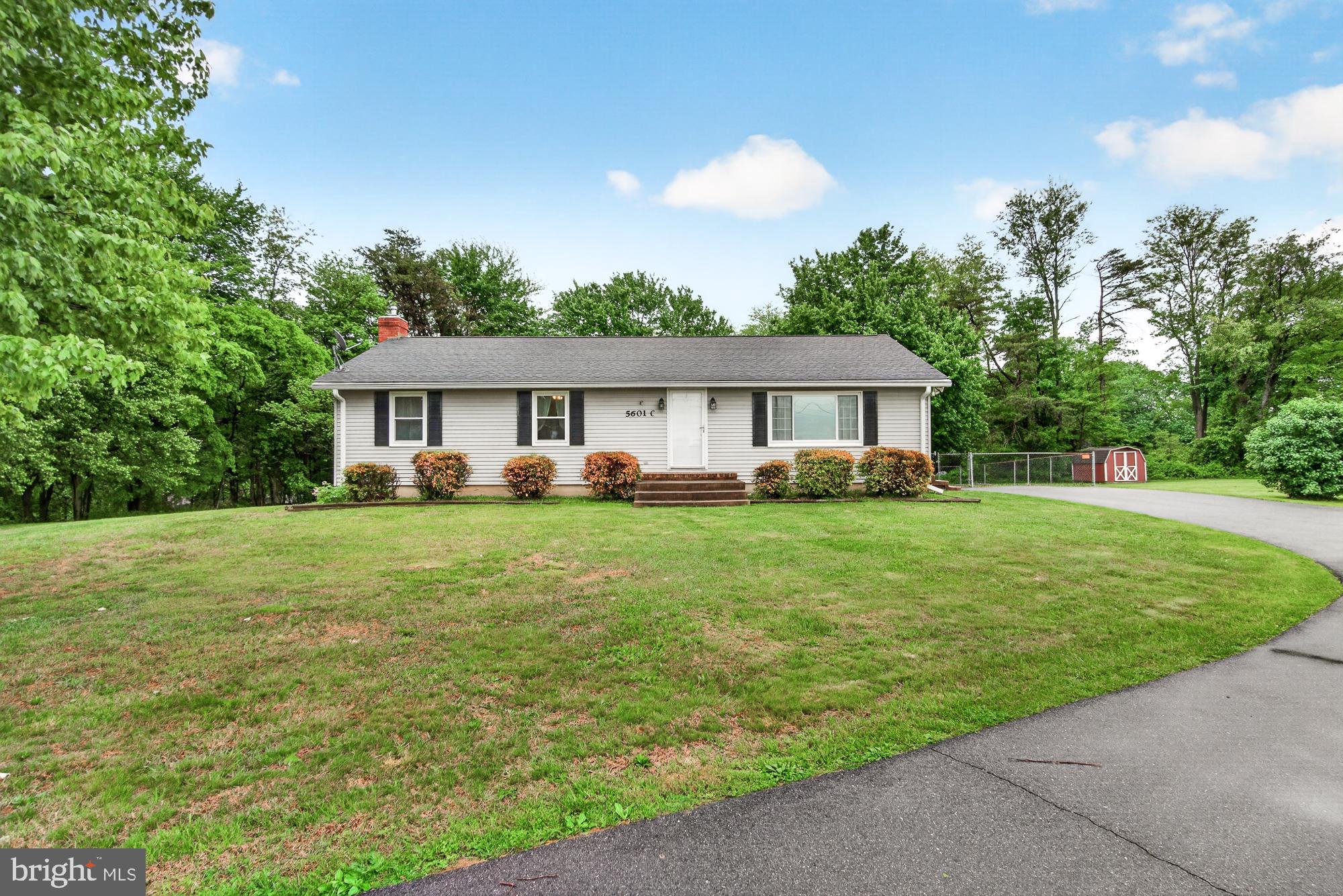 5601 Woodville Road Mount Airy, MD 21771 - Photo 5 of 54 a front view of a house with a yard table and chairs