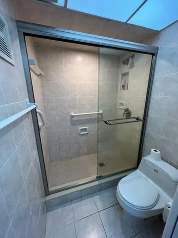 a bathroom with a toilet and a shower