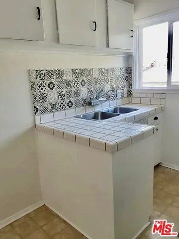 a bedroom with a bed and a mirror