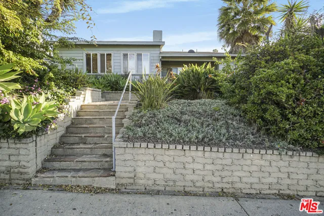 a view of a house with a flower garden