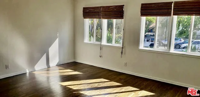 an empty room with wooden floor