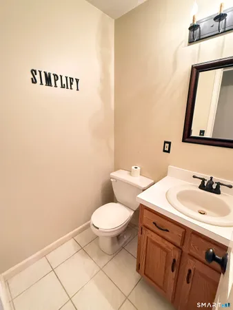 a bathroom with a sink a toilet and mirror