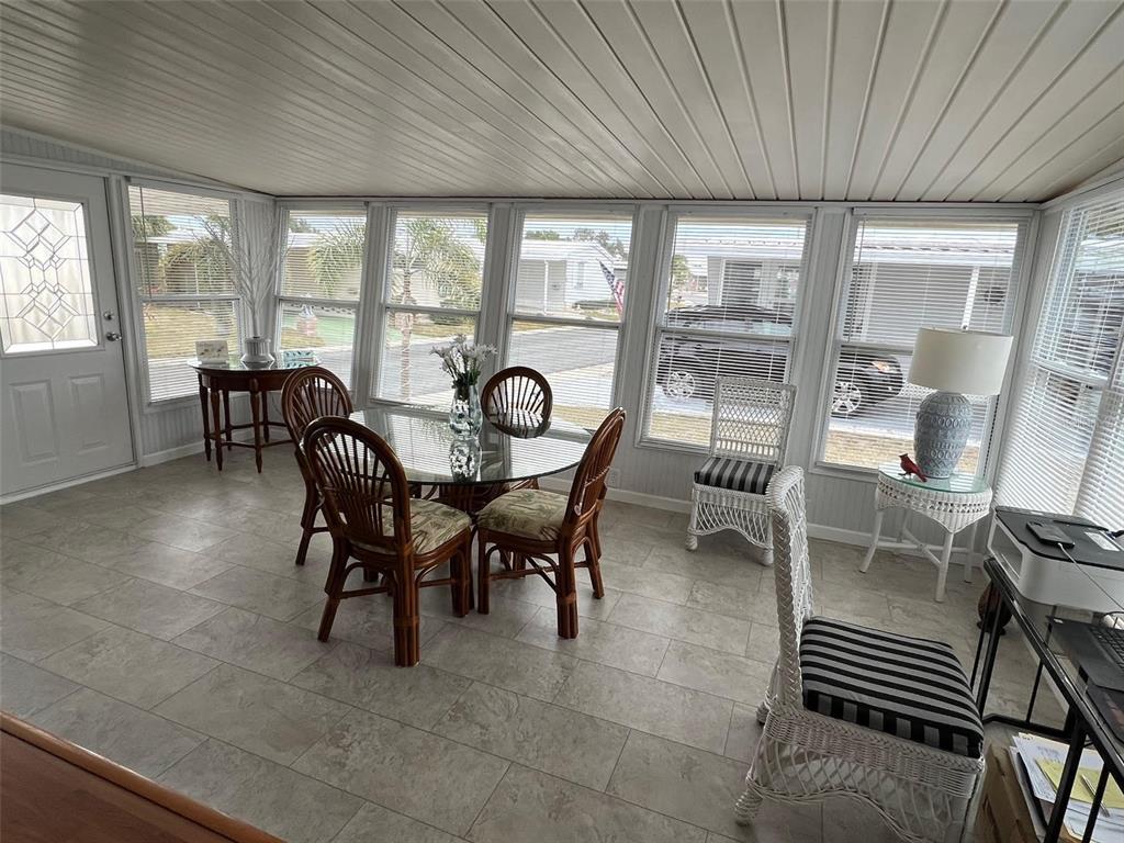 44 Thatch Palm Street West Largo, FL 33770 - Photo 11 of 25 a view of a dining room with furniture window and outside view