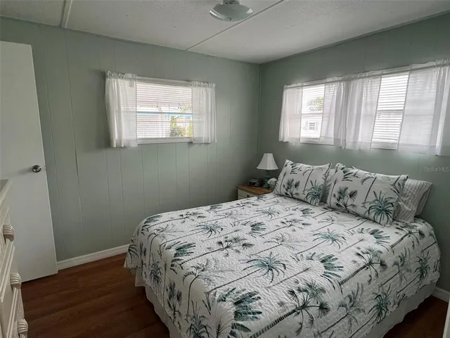 a large bed sitting in a bedroom next to a window
