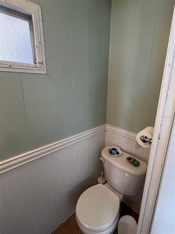 44 Thatch Palm Street West Largo, FL 33770 - Photo 16 of 25 a white toilet sitting next to a small window