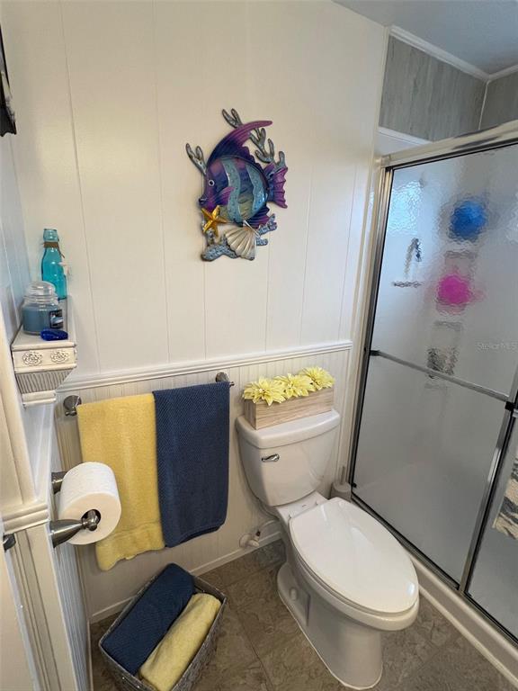 44 Thatch Palm Street West Largo, FL 33770 - Photo 23 of 25 a white toilet sitting next to a bathroom sink and a tub