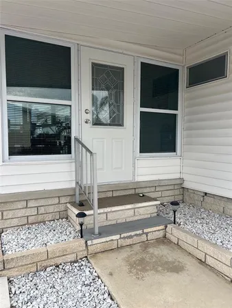 a view of a house with a door and wooden floor
