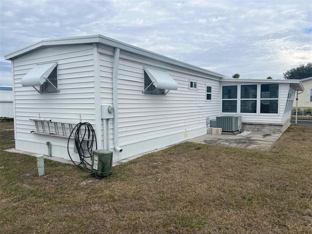 44 Thatch Palm Street West Largo, FL 33770 - Photo 5 of 25 a view of a house with a patio and a yard