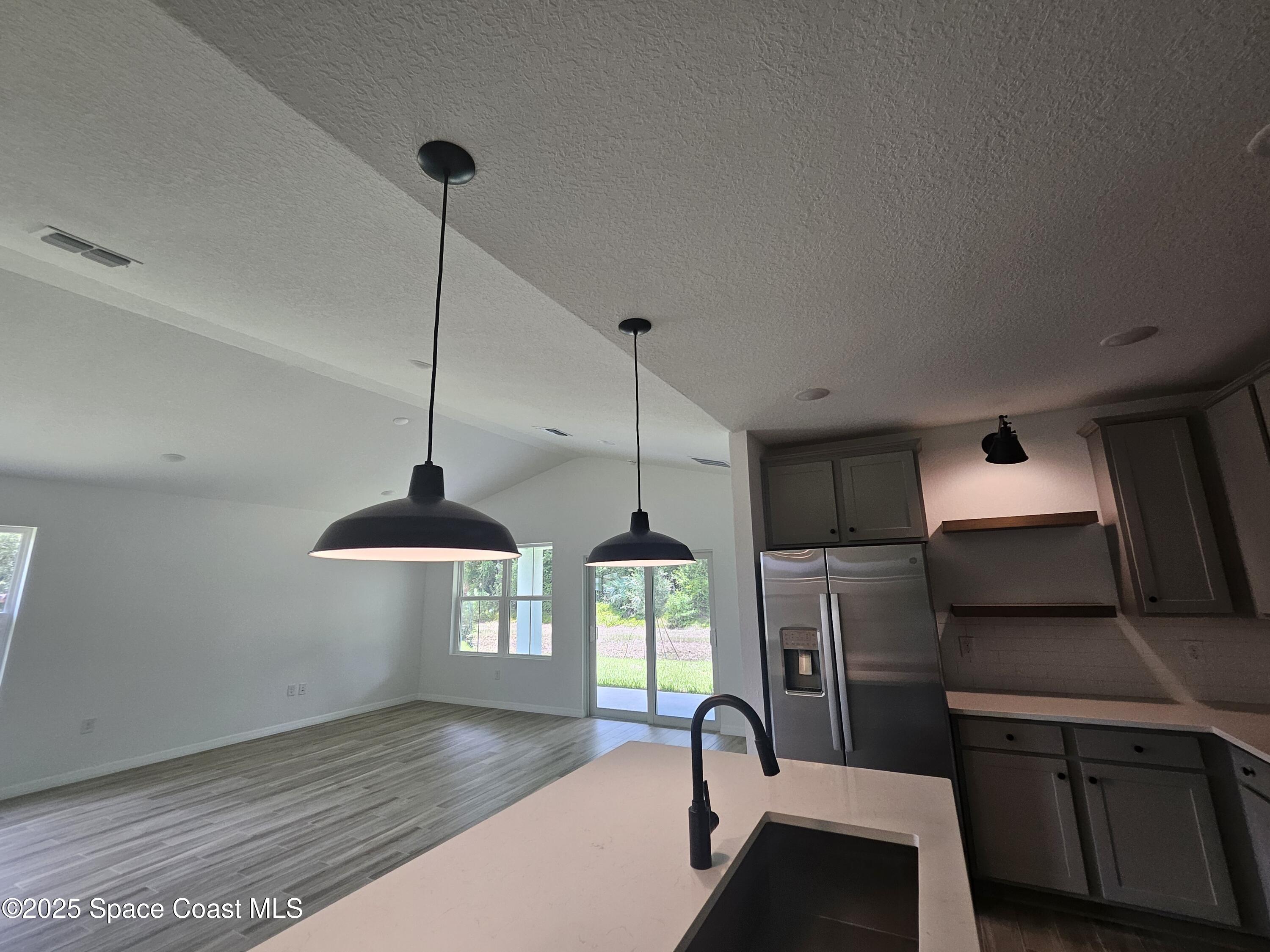 1077 Duxbury Road Southeast Palm Bay, FL 32909 - Photo 2 of 15 Kitchen & great room
