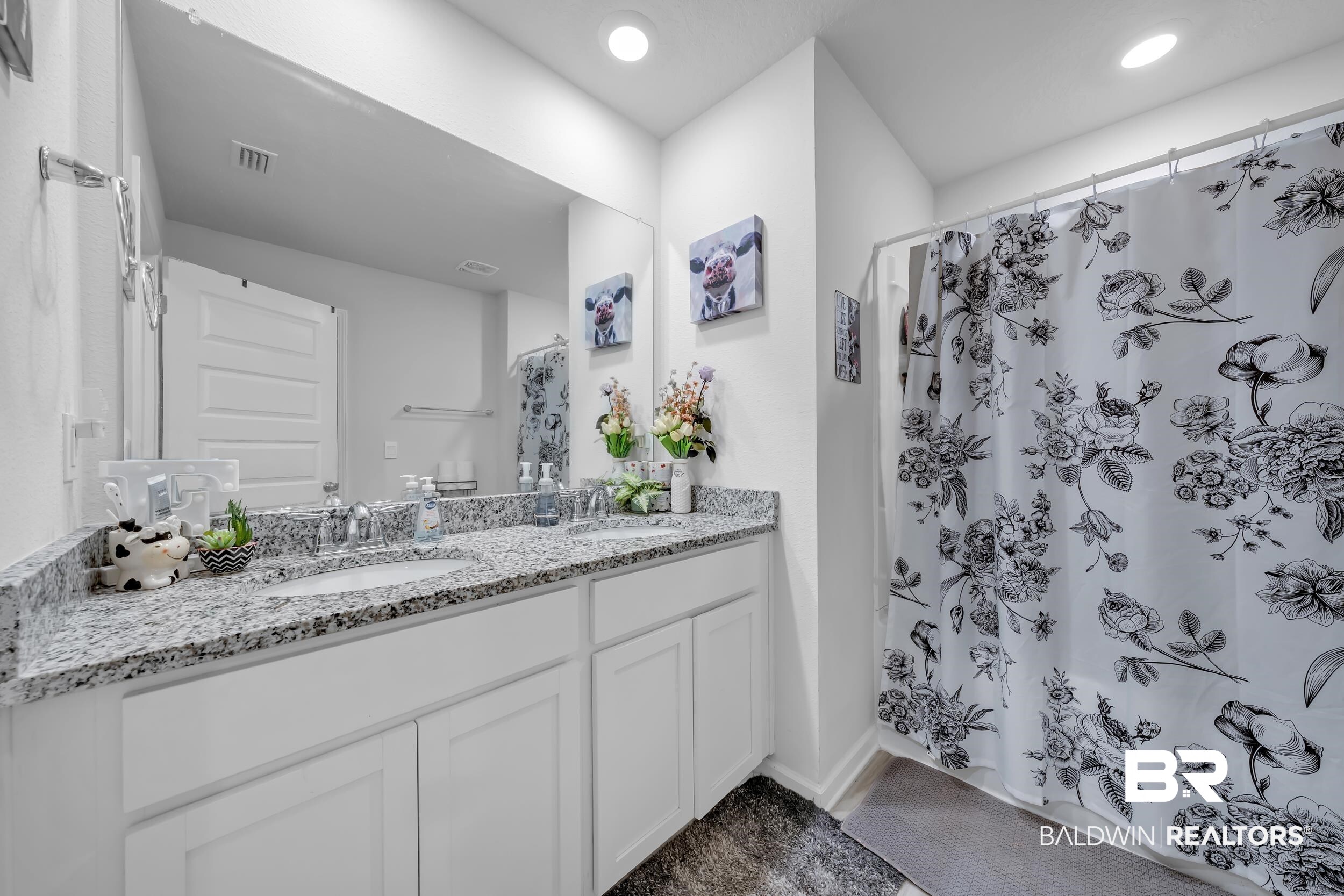 24271 Ringneck Loop Elberta, AL 36530 - Photo 23 of 44 Bathroom featuring a dual vanity with a speckled countertop, undermount sinks, chrome faucets, and white cabinetry