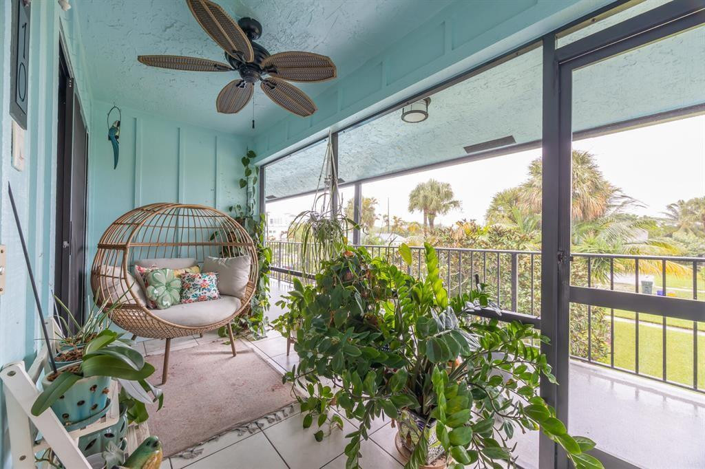 a living room filled with furniture and a floor to ceiling window