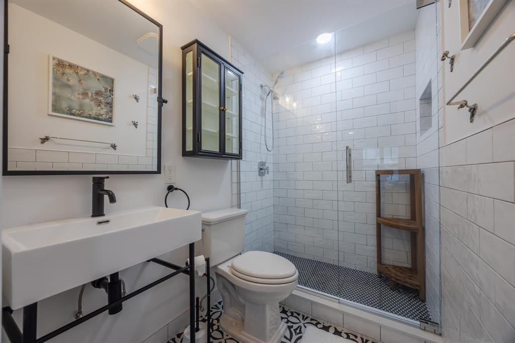 201 Southwest 1st Street, Unit 10 Boca Raton, FL 33432 - Photo 17 of 28 a bathroom with a sink a toilet and mirror