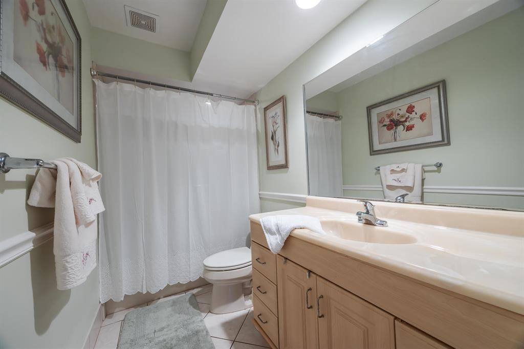 201 Southwest 1st Street, Unit 10 Boca Raton, FL 33432 - Photo 24 of 28 a bathroom with a sink toilet and shower