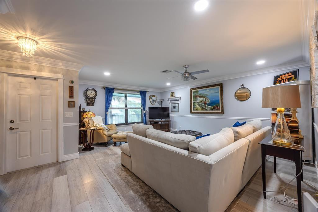 201 Southwest 1st Street, Unit 10 Boca Raton, FL 33432 - Photo 4 of 28 a living room with furniture and a wooden floor