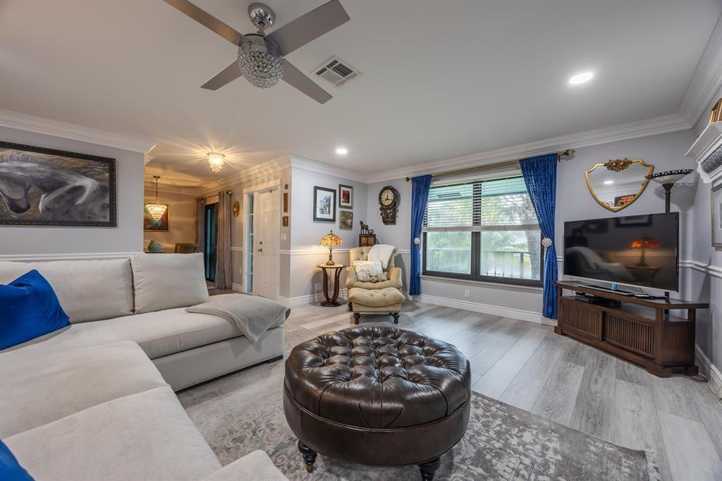 201 Southwest 1st Street, Unit 10 Boca Raton, FL 33432 - Photo 6 of 28 a living room with furniture and a flat screen tv