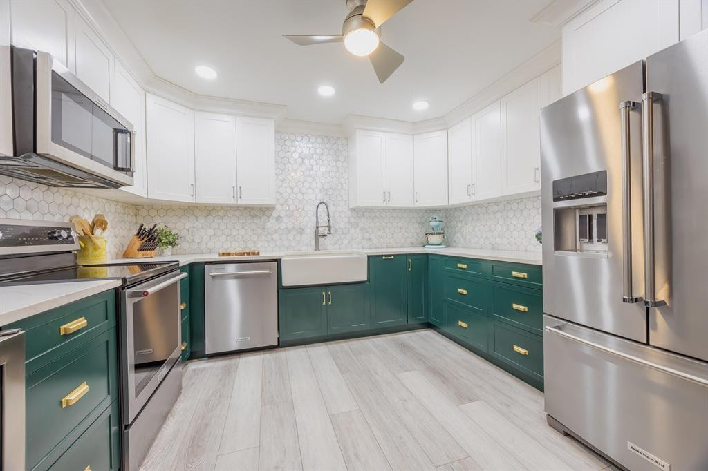 201 Southwest 1st Street, Unit 10 Boca Raton, FL 33432 - Photo 10 of 28 a kitchen with stainless steel appliances granite countertop a refrigerator a sink dishwasher a stove top oven a refrigerator with island and cabinets