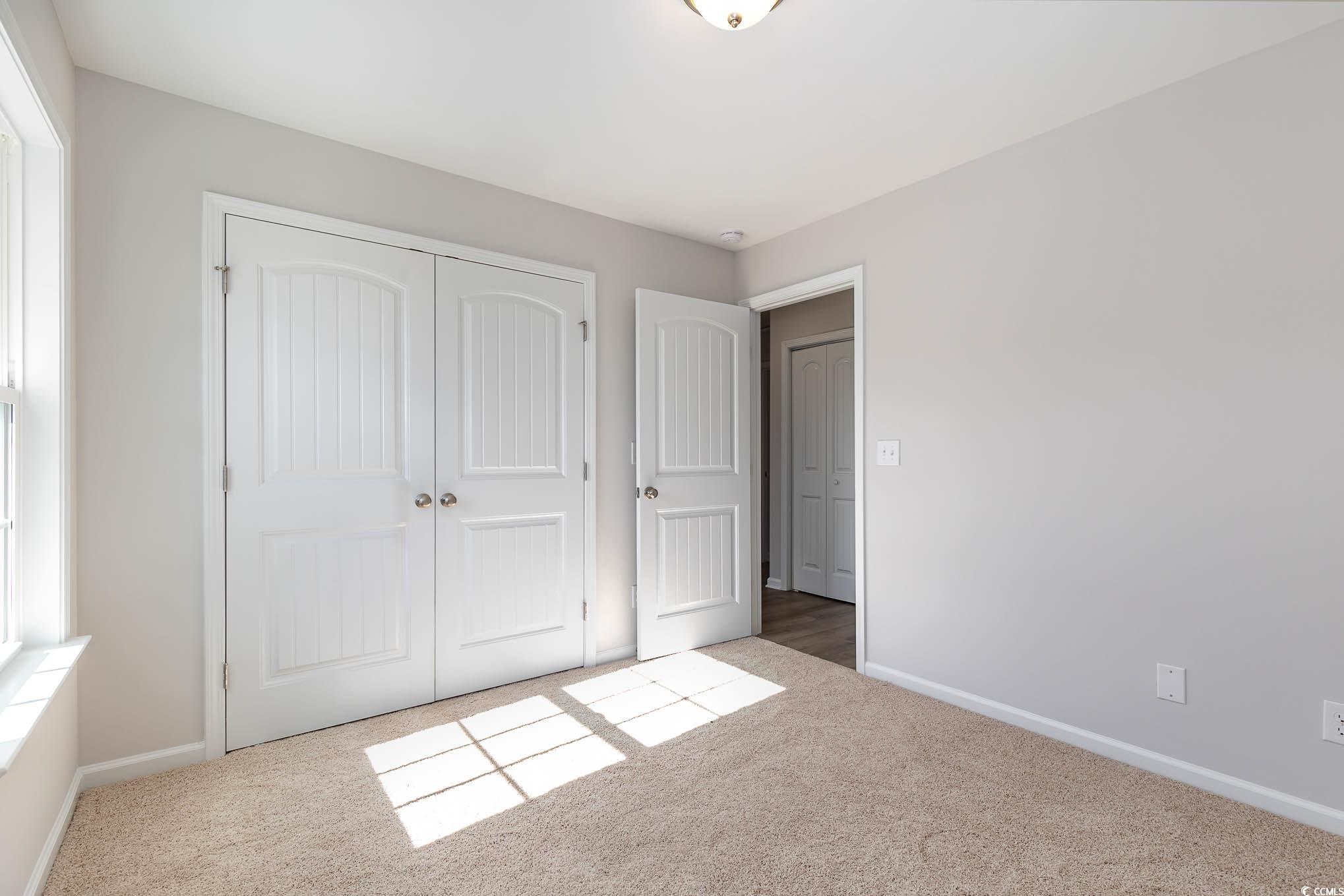 355 5th Avenue Aynor, SC 29511 - Photo 12 of 15 Unfurnished bedroom featuring carpet floors and a closet