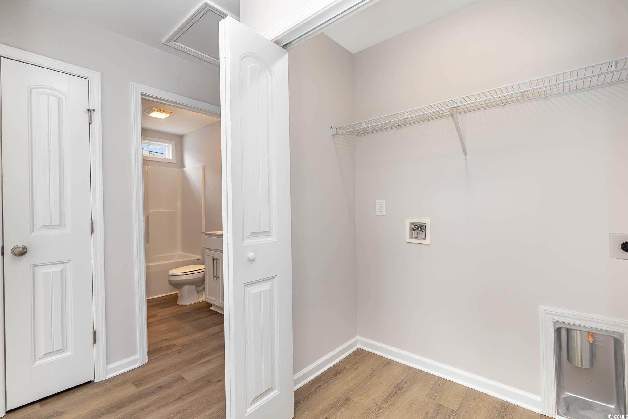 355 5th Avenue Aynor, SC 29511 - Photo 15 of 15 Washroom featuring light wood-style floors, washer hookup, and hookup for an electric dryer