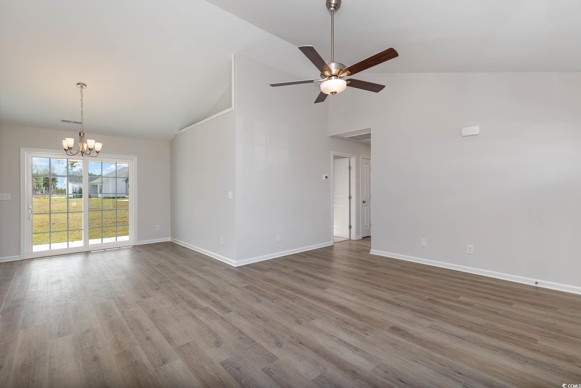 355 5th Avenue Aynor, SC 29511 - Photo 2 of 15 Unfurnished living room featuring wood finished floors, high vaulted ceiling, a chandelier, and ceiling fan