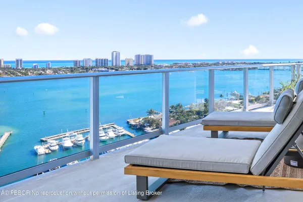 a living room with patio furniture and a large window