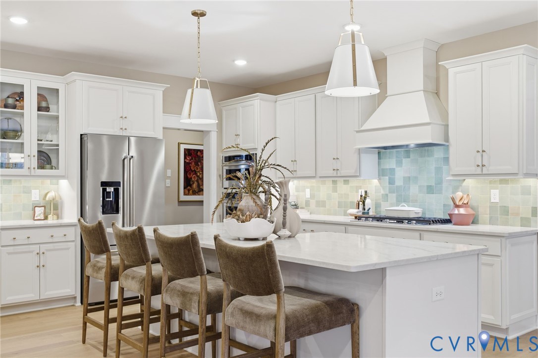 4023 Tuckmar Ridge Drive Moseley, VA 23120 - Photo 2 of 21 a kitchen with stainless steel appliances kitchen island a table chairs refrigerator and sink