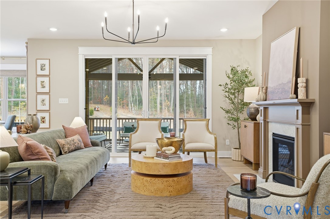 4023 Tuckmar Ridge Drive Moseley, VA 23120 - Photo 7 of 21 a living room with furniture a fireplace and a chandelier