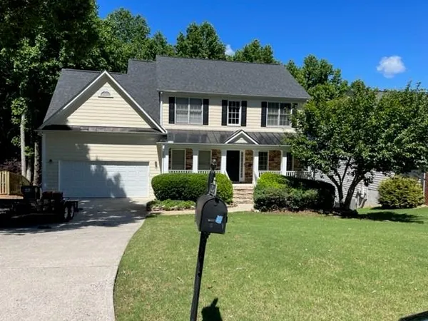 a front view of a house with a yard