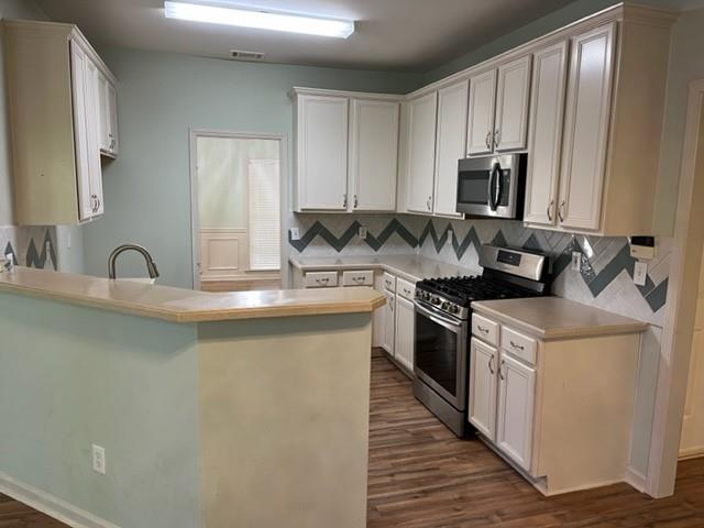 2945 Highland Pass Alpharetta, GA 30004 - Photo 8 of 29 a kitchen with stainless steel appliances a sink stove and cabinets