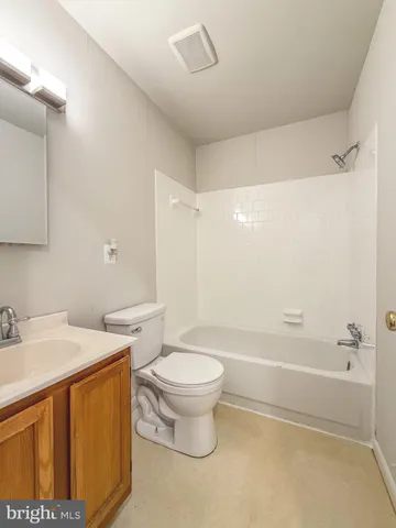 a bathroom with a sink toilet vanity and shower