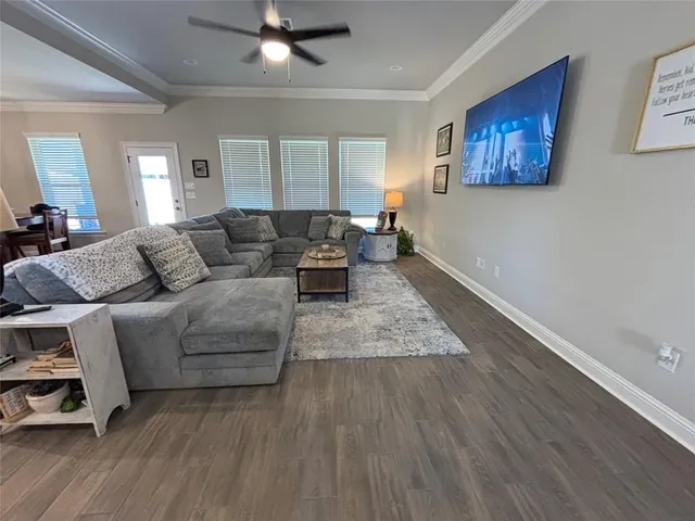 a living room with furniture and wooden floor