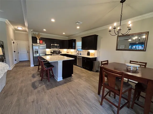 a kitchen with a table and chairs in it