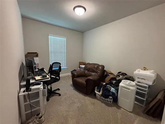 a room with furniture a air conditioner and a window