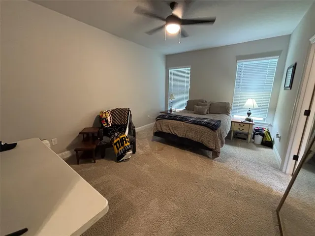 a bed room with furniture and a ceiling fan