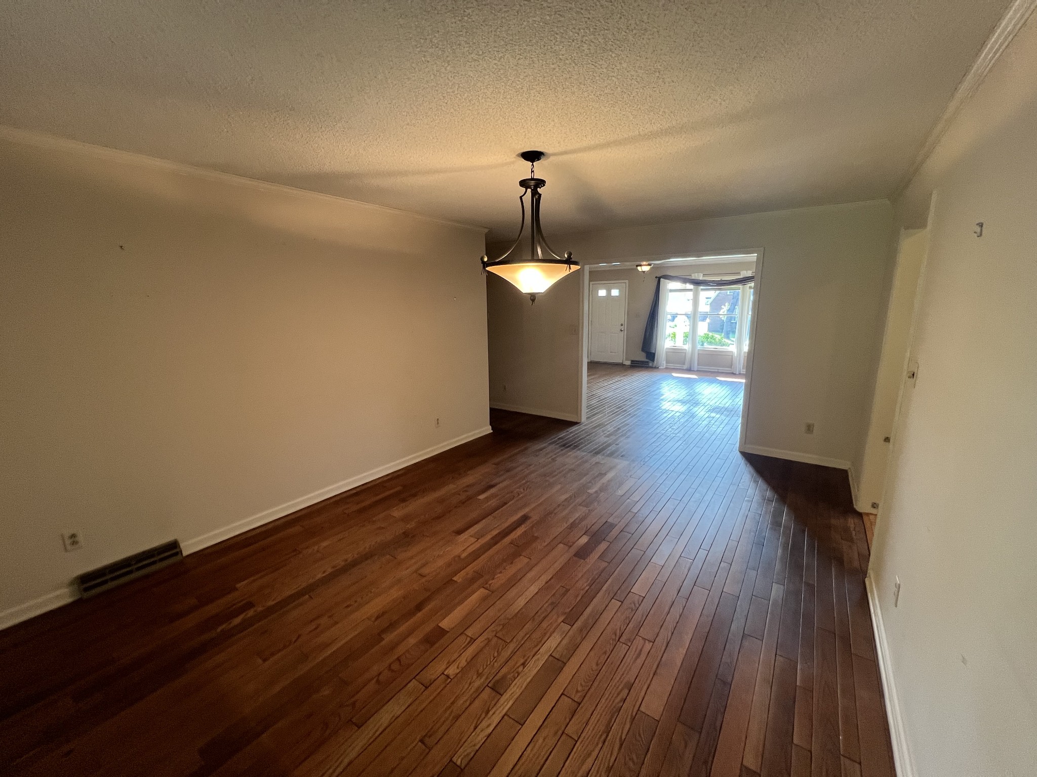 212 North 3rd Street Pulaski, TN 38478 - Photo 12 of 38 a hallway with a wooden floor and chandelier