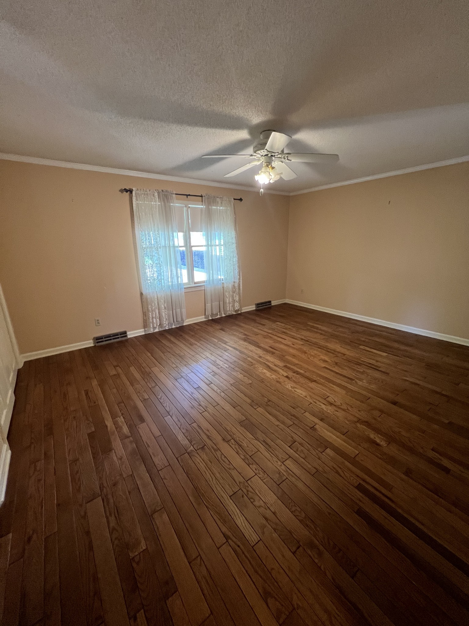 212 North 3rd Street Pulaski, TN 38478 - Photo 13 of 38 a view of empty room with wooden floor and fan