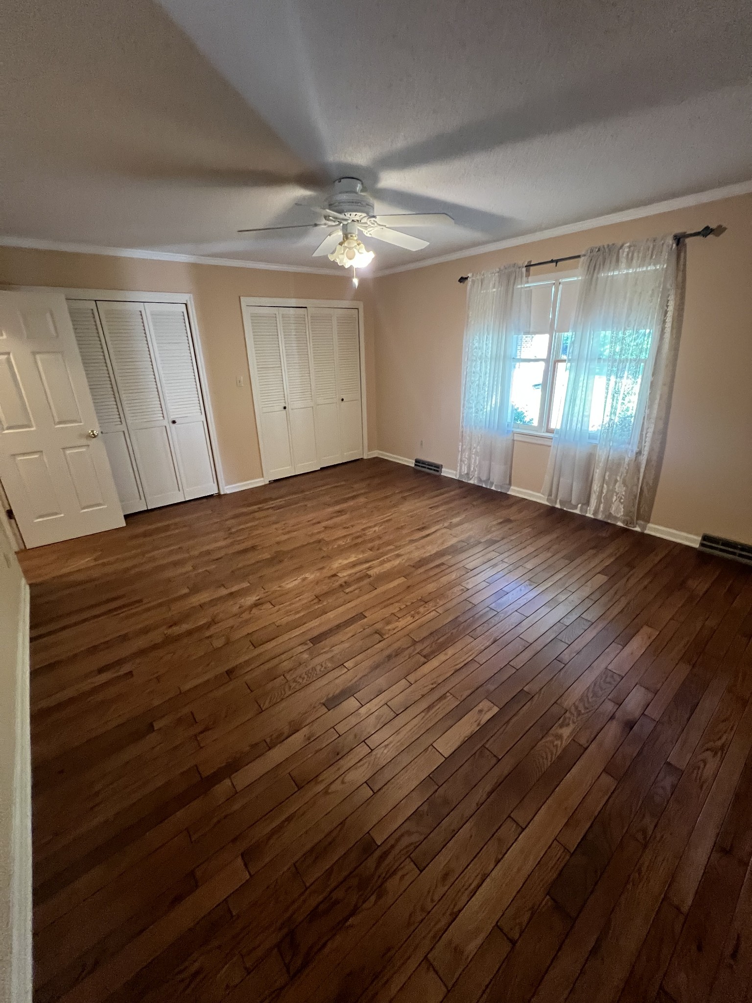 212 North 3rd Street Pulaski, TN 38478 - Photo 15 of 38 a view of empty room with wooden floor and fan