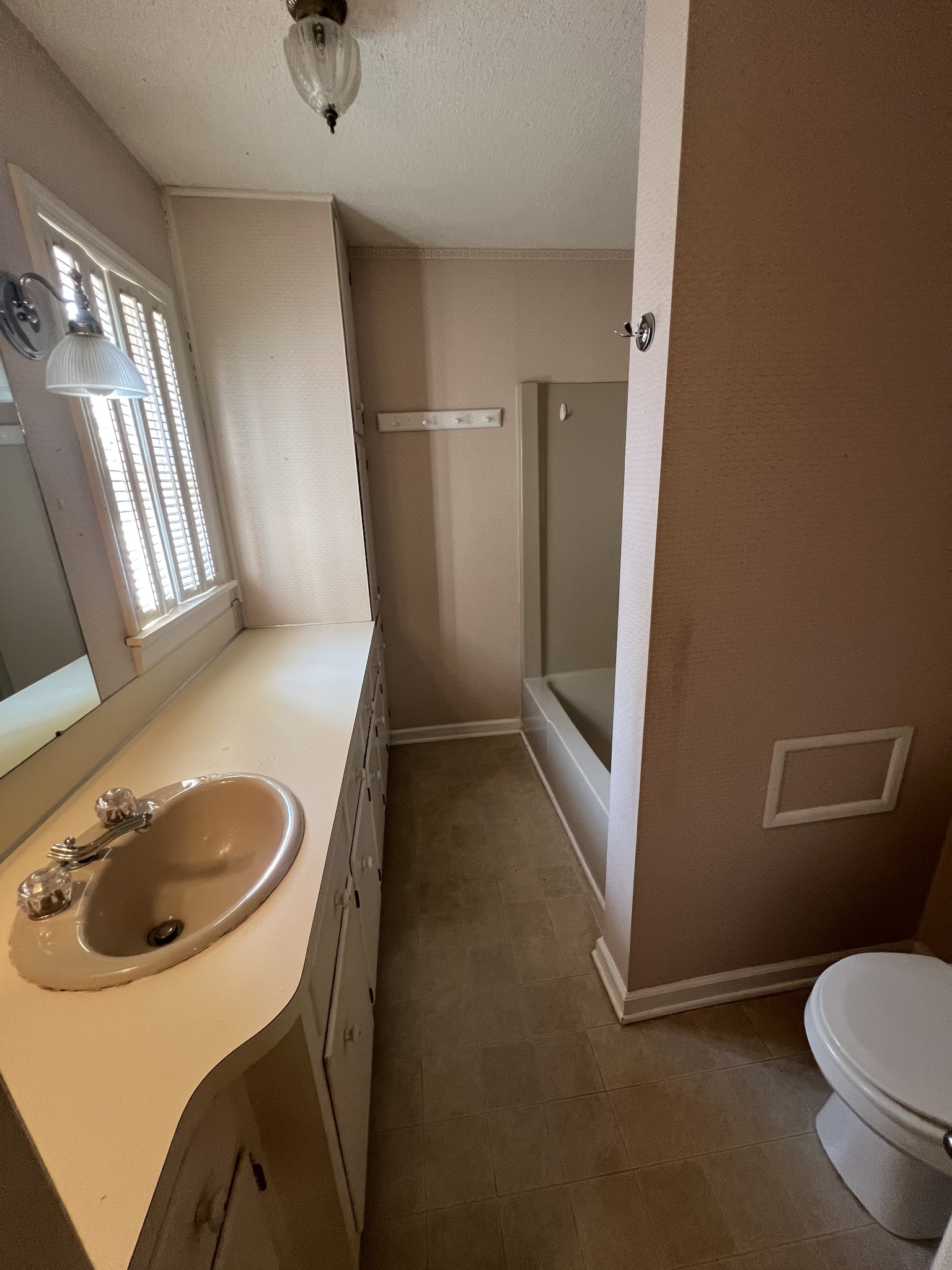 212 North 3rd Street Pulaski, TN 38478 - Photo 16 of 38 a bathroom with a sink toilet and mirror