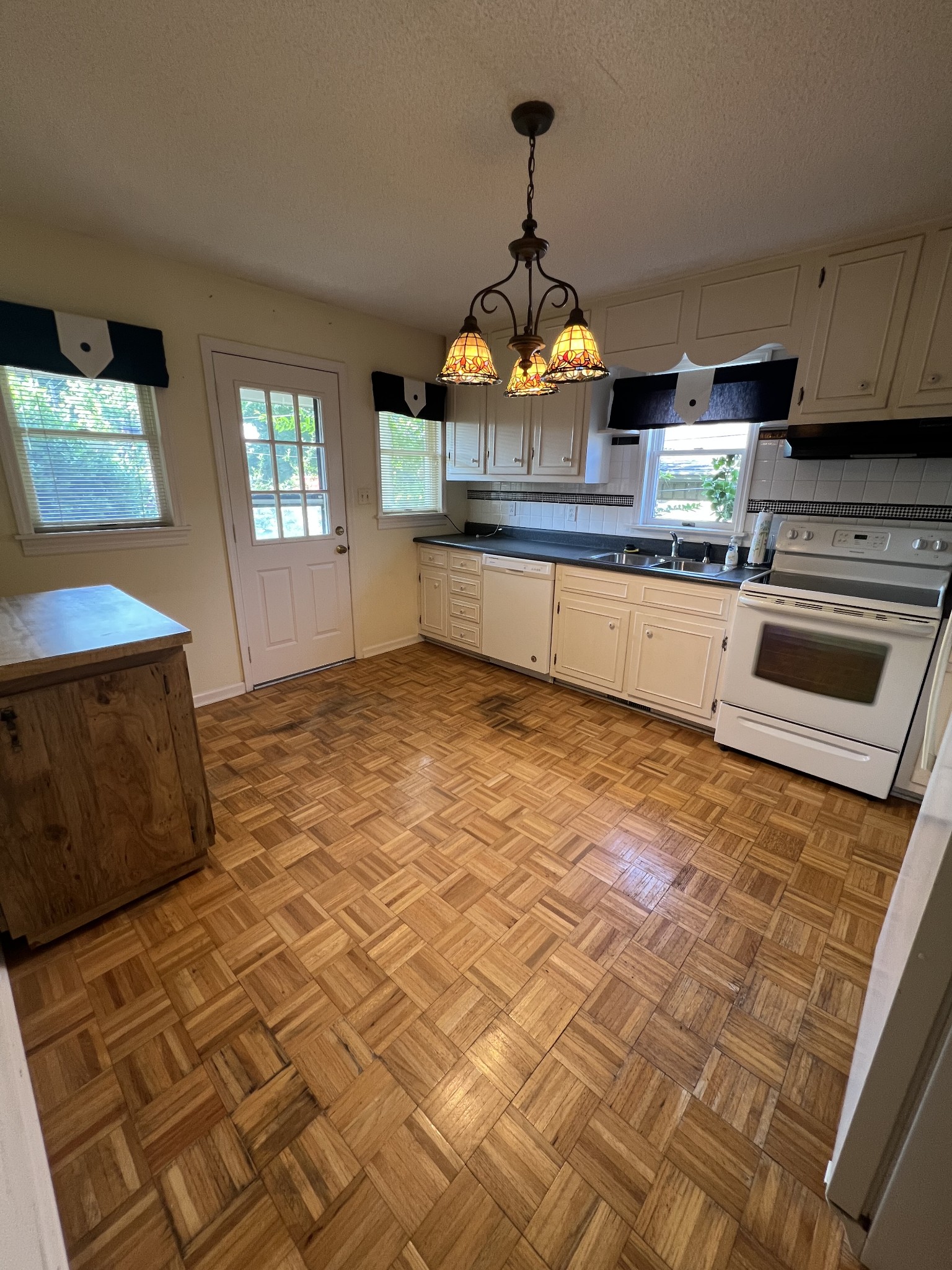 212 North 3rd Street Pulaski, TN 38478 - Photo 21 of 38 a kitchen with stainless steel appliances granite countertop a sink a stove and a wooden floors