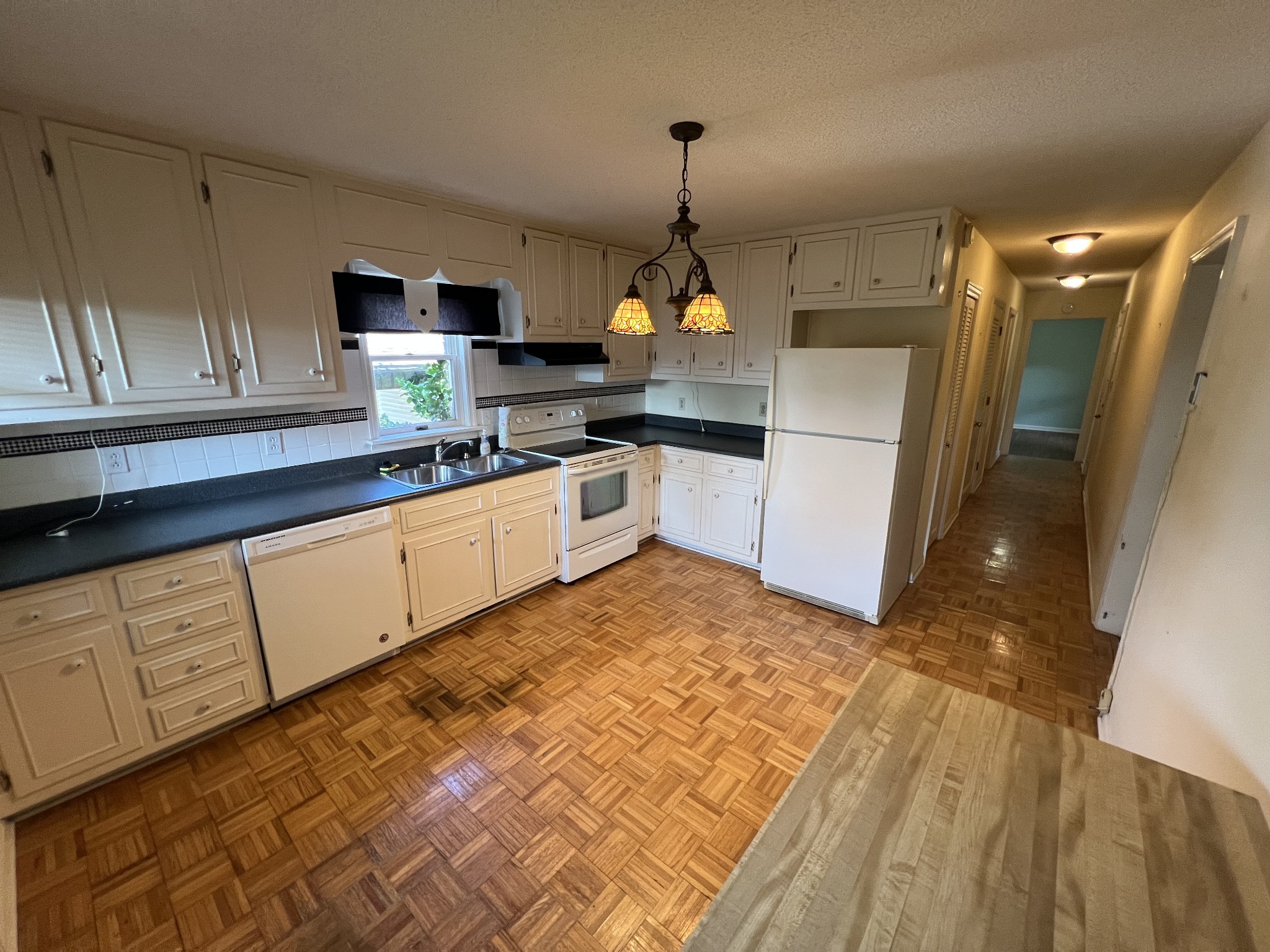 212 North 3rd Street Pulaski, TN 38478 - Photo 22 of 38 a kitchen with granite countertop white cabinets and white appliances